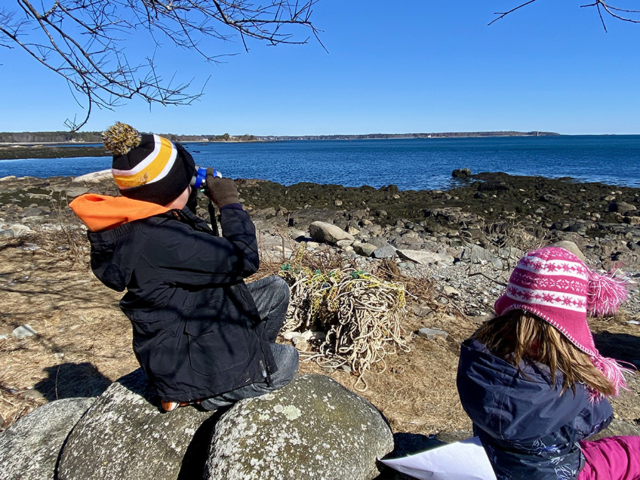 Treks campers looking out to sea with binoculars
